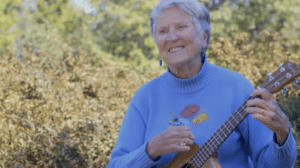 senior woman playing a ukulele