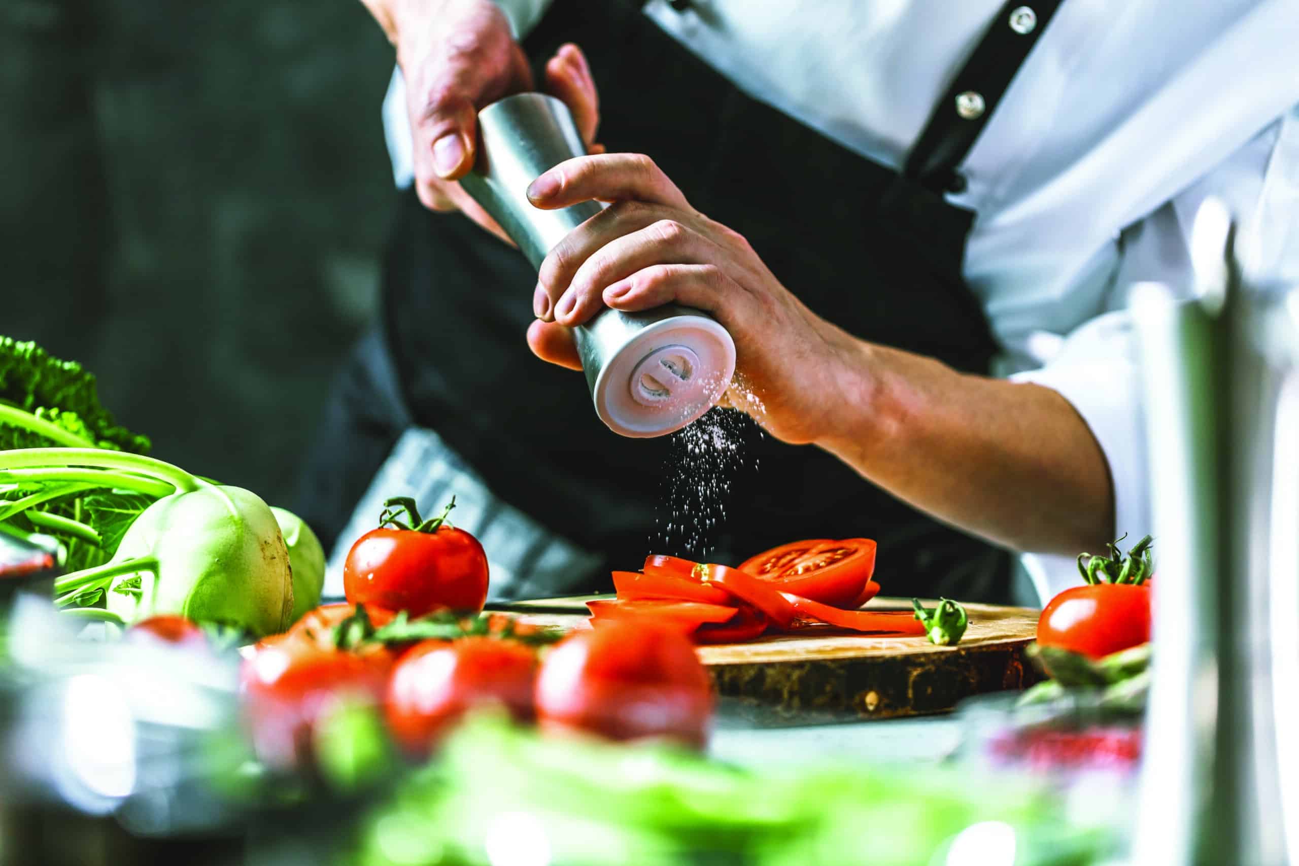 Chef cook preparing vegetables in his kitchen.