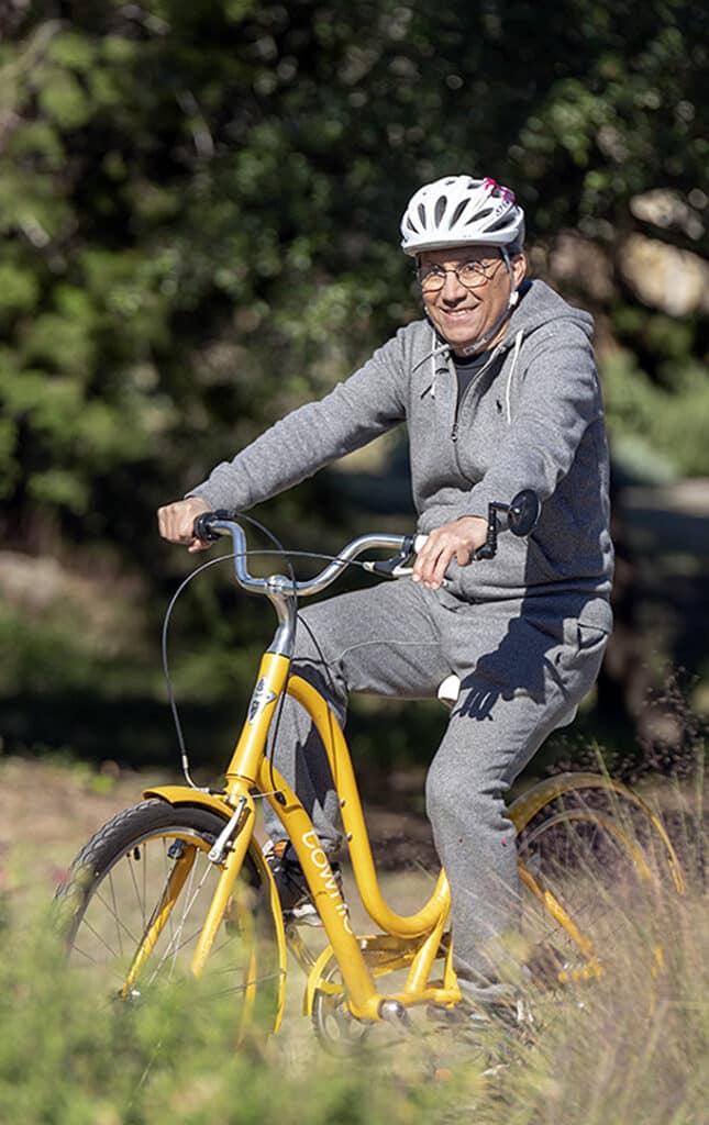 senior man outside bicycling at Longhorn Village