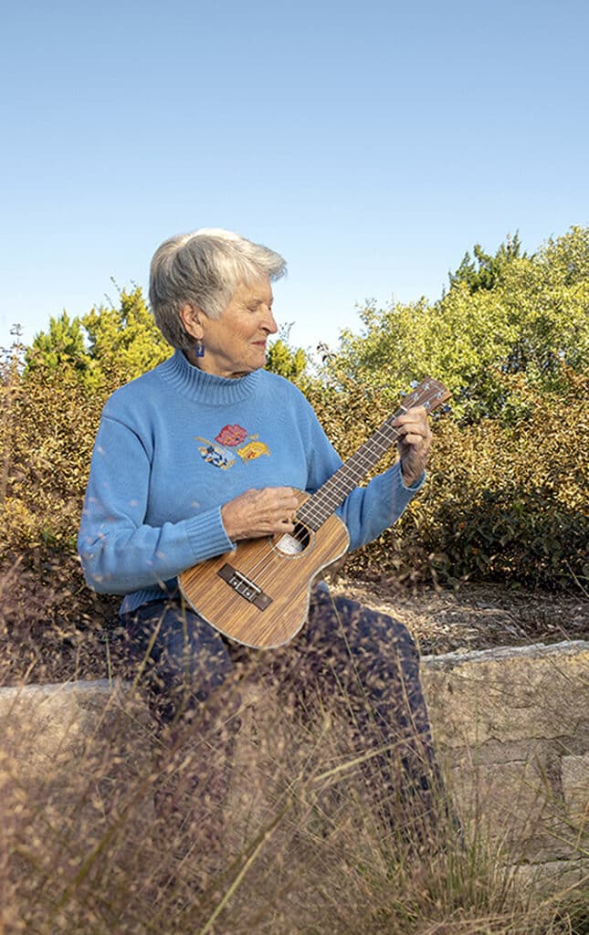 senior woman playing a ukulele