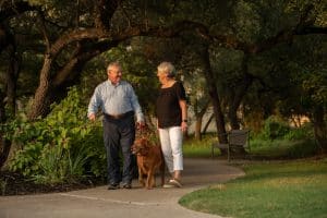 senior couple taking their dog for a walk