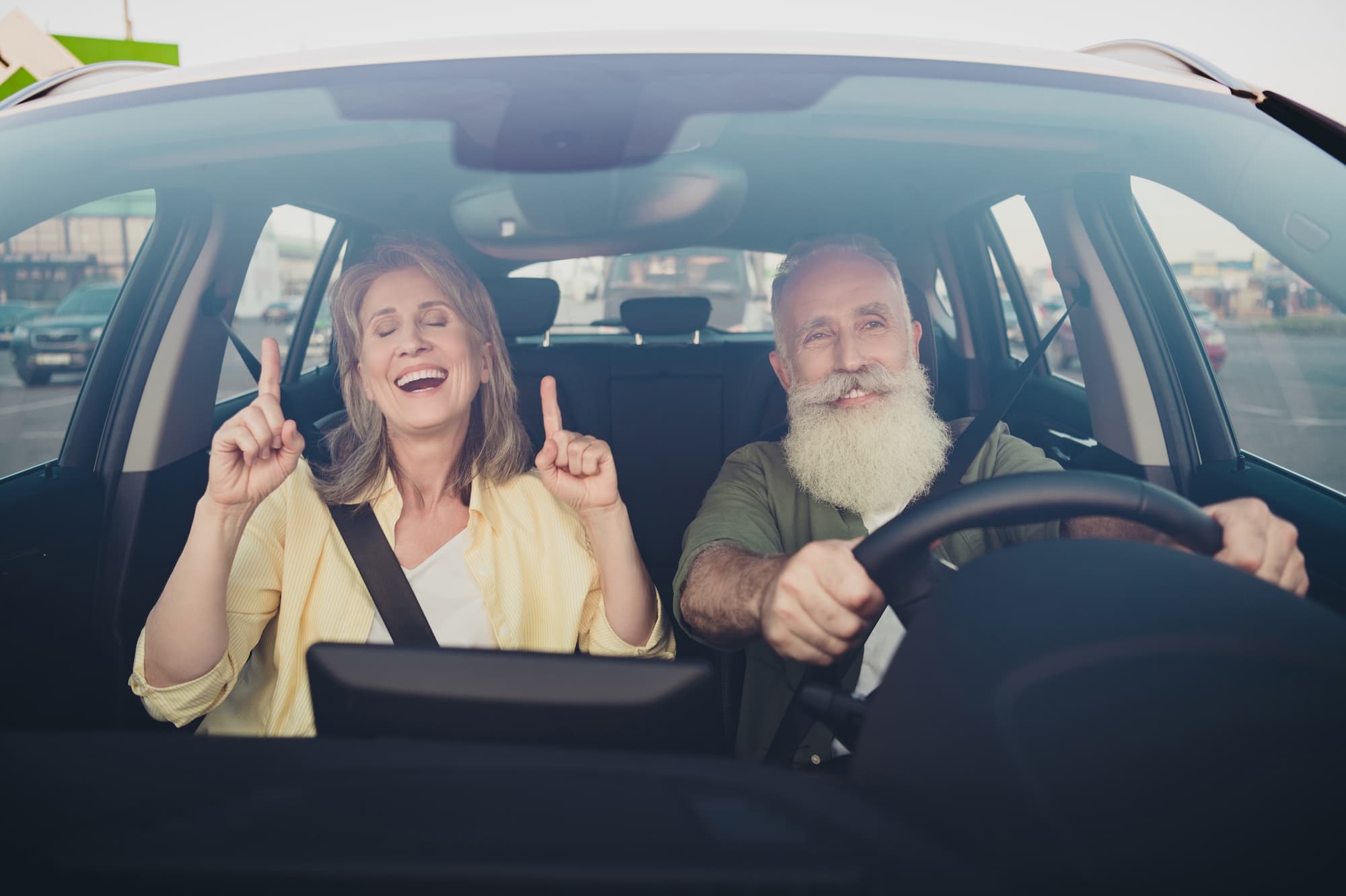 seniors enjoying their new car