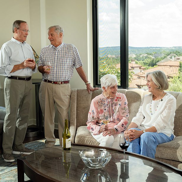 two senior couples chatting with one another in one of our indoor seating lounges