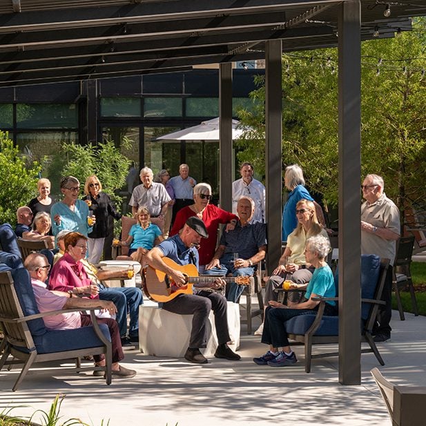 an outdoor concert gathering at Longhorn Village with many residents in attendance