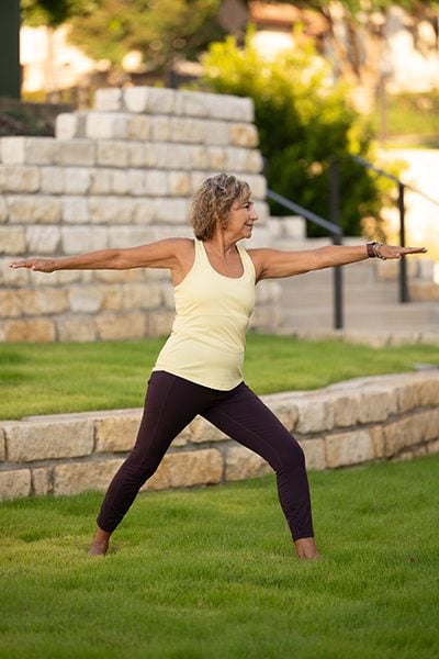 a woman practicing yoga in the outdoor campus