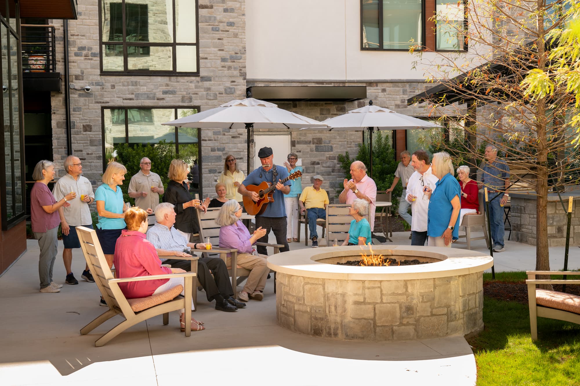 Longhorn Village residents hanging outdoors with live music, bonding over a bonfire
