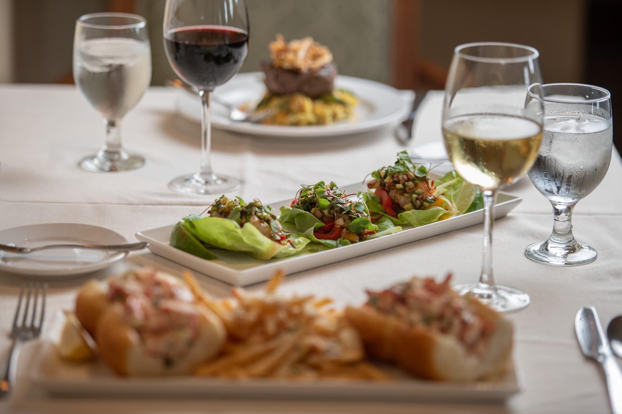 an ornate dining table set with various appetizers, including a tray of gourmet tacos.