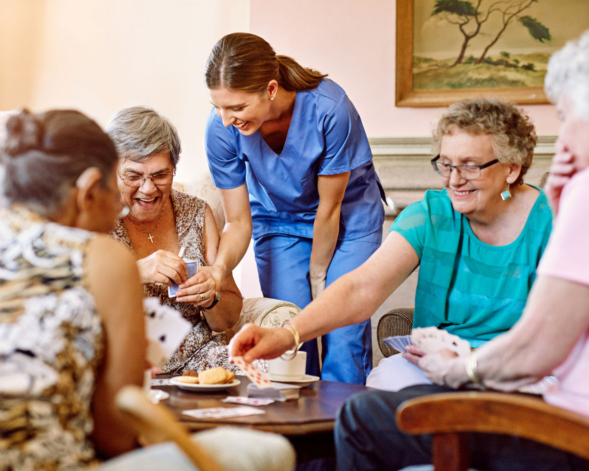 group of senior women playing cards at an independent living community